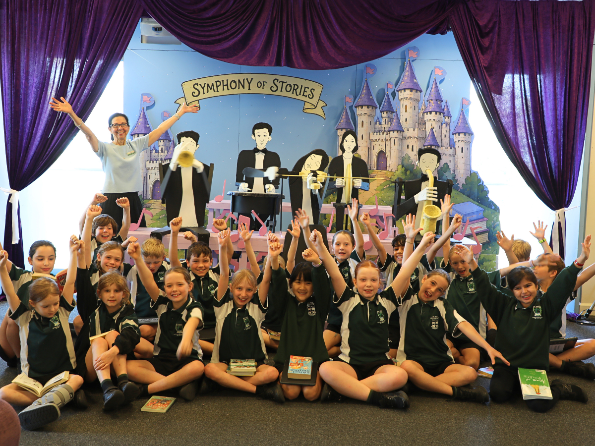 Teacher-Librarian Filia Papamanolis with students in front of the school library's Book Week installation.