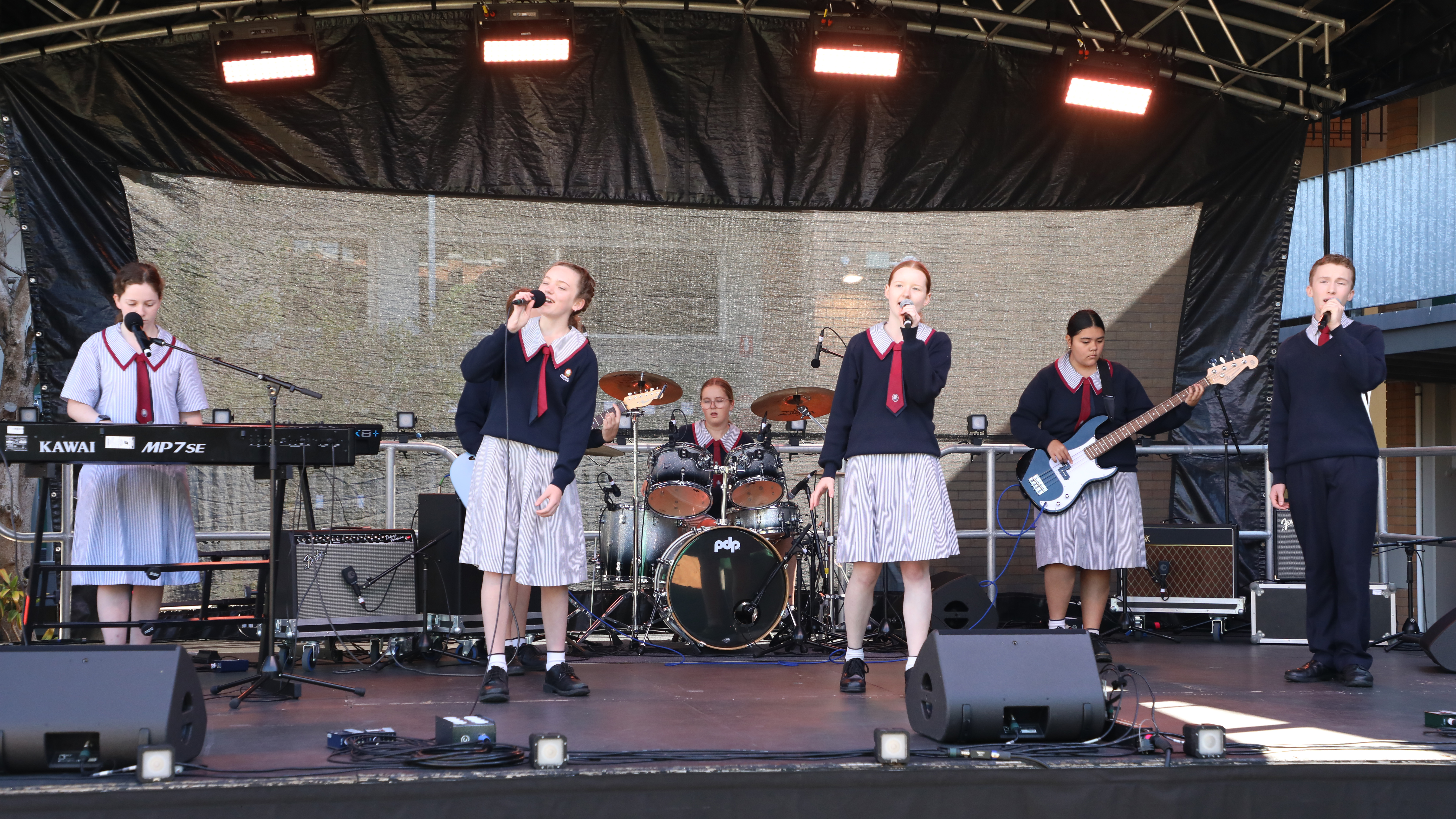 armel College, Thornlands students perform in the Contemporary Ensemble category. (From left to right) Year 8 and 10 students Andrea (on keys), Rory (singer), Addison (on guitar), Tahlia (drums), Sophie (signer), Elisabeth (bass), and Alexander (singer)