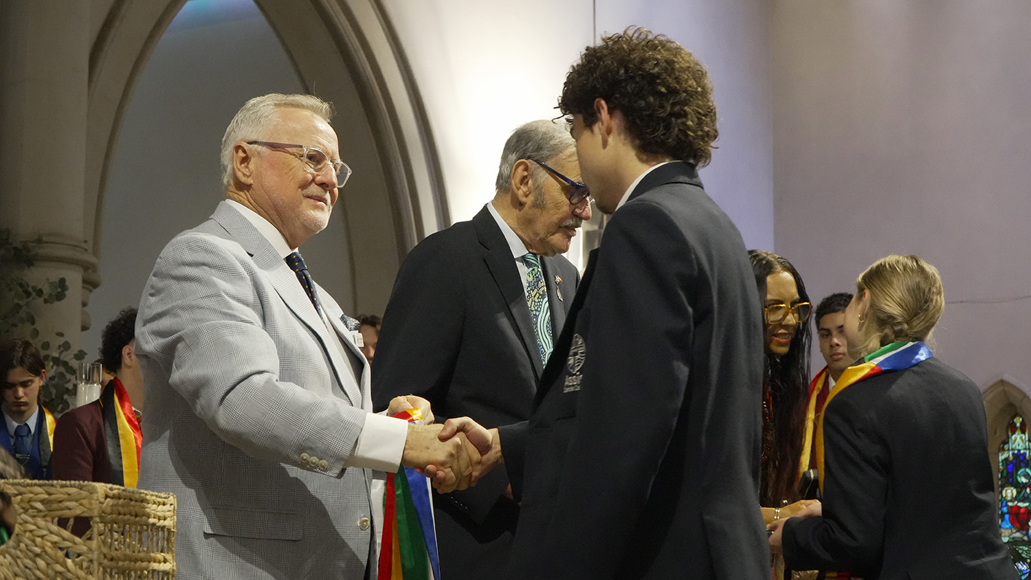 Ross Tarlinton congratulates an Assisi Catholic College Upper Coomer graduate