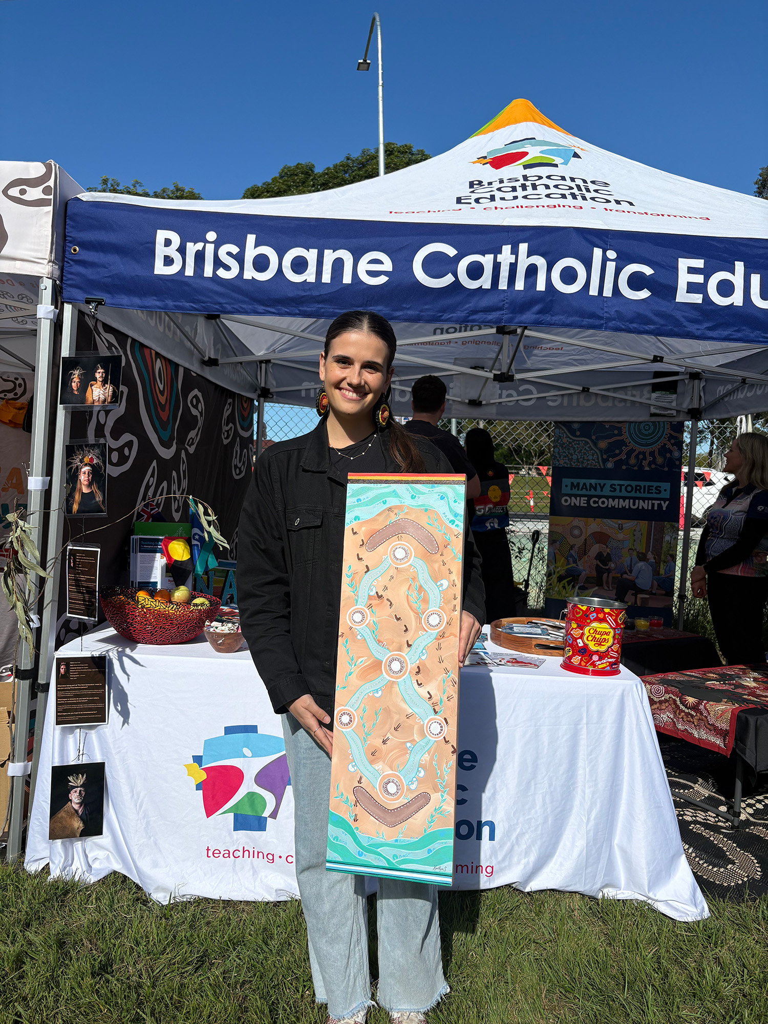 Gamilaroi woman and St Flannan's School, Zillmere Year 2 teacher Kaitlyn Spiteri with her painting 'Together.'