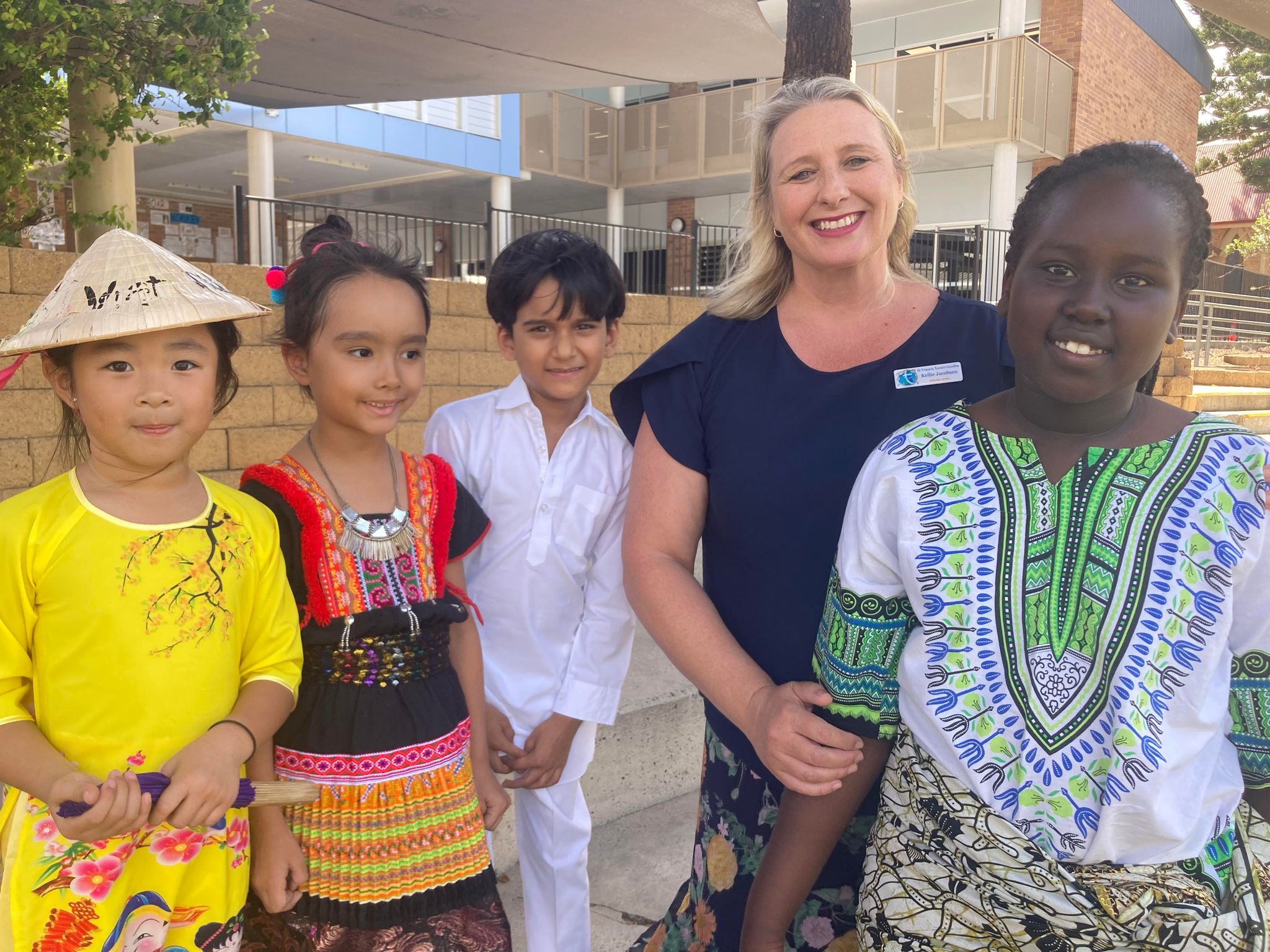 Principal Kellie Jacobsen with St Franis Xavier Primary School students in their traditional dress 2.jpg